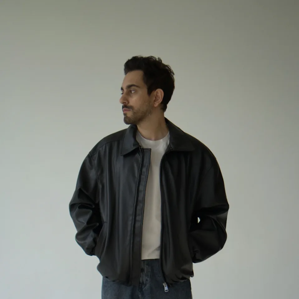 Studio portrait of Bilal Khan in a leather jacket